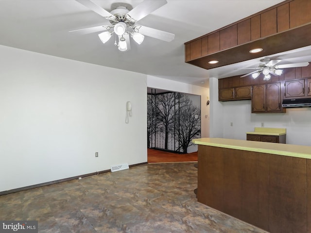 1700 Mcdowell Rd, Greencastle, PA 17225 - kitchen with ceiling fan, under cabinet range hood, baseboards, dark brown cabinetry, and light countertops