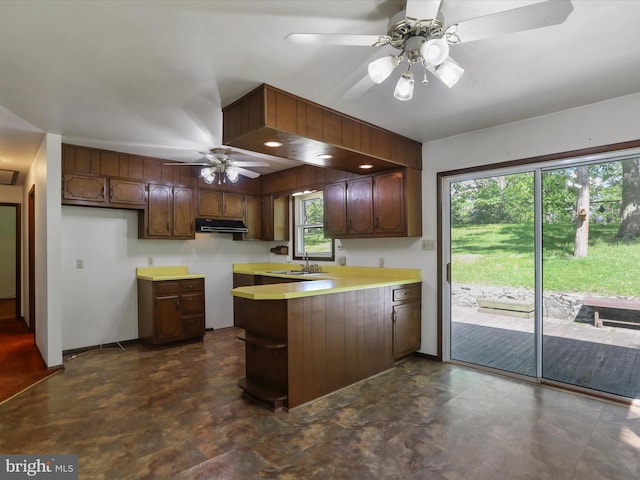 1700 Mcdowell Rd, Greencastle, PA 17225 - kitchen with a peninsula, under cabinet range hood, ceiling fan, a sink, and light countertops
