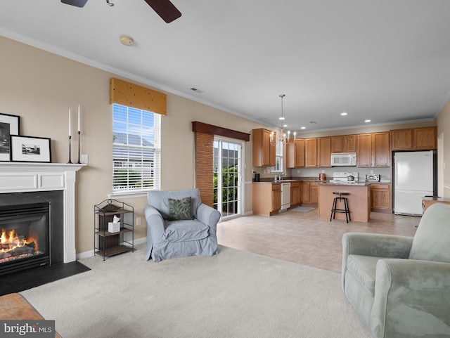 64 Fieldmaple Dr, Camden Wyoming, DE 19934 - living area featuring crown molding, recessed lighting, a chandelier, a fireplace with flush hearth, and ceiling fan