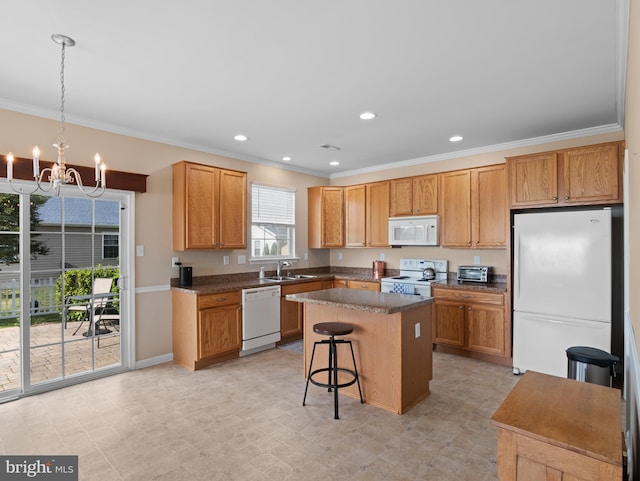 64 Fieldmaple Dr, Camden Wyoming, DE 19934 - kitchen featuring white appliances, crown molding, a chandelier, a center island, and a breakfast bar