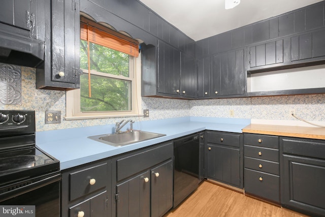 207 Wilderness Ln, Fredericksburg, VA 22401 - kitchen with black appliances, a sink, under cabinet range hood, light countertops, and light wood finished floors