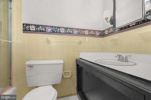 207 Wilderness Ln, Fredericksburg, VA 22401 - full bathroom featuring tile walls, toilet, vanity, and a wainscoted wall