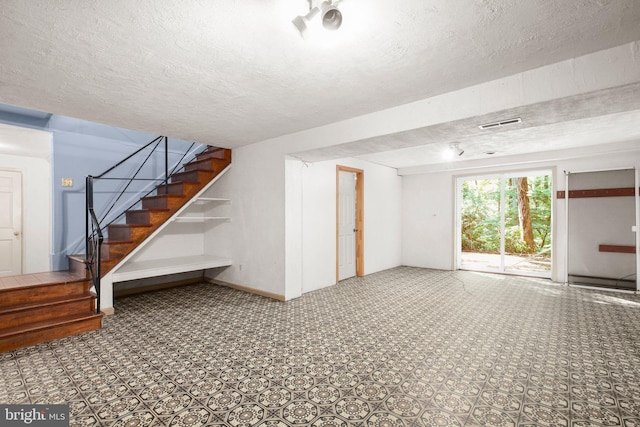 207 Wilderness Ln, Fredericksburg, VA 22401 - below grade area with stairway and a textured ceiling