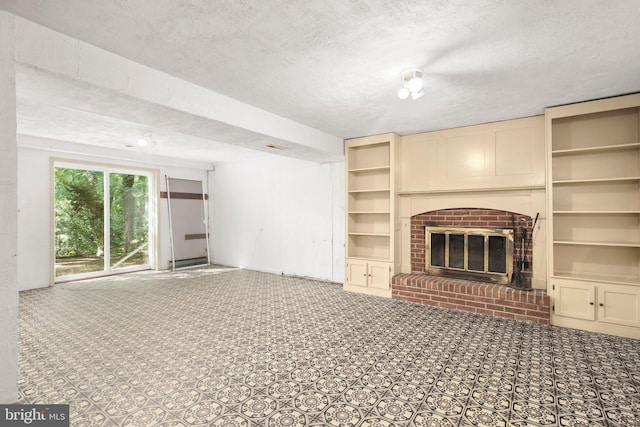 207 Wilderness Ln, Fredericksburg, VA 22401 - unfurnished living room featuring a fireplace, a textured ceiling, and built in shelves