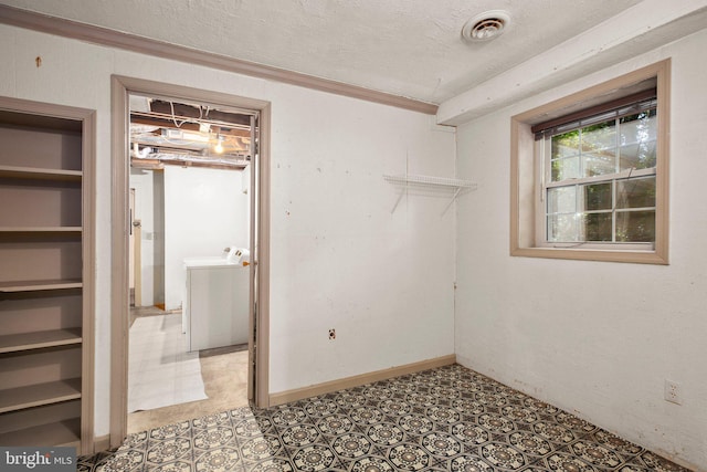 207 Wilderness Ln, Fredericksburg, VA 22401 - empty room with washer and clothes dryer, a textured ceiling, and crown molding
