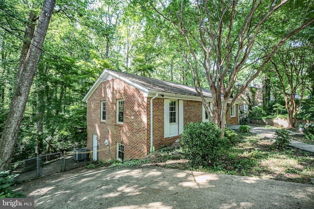 207 Wilderness Ln, Fredericksburg, VA 22401 - view of home's exterior featuring brick siding, a gate, and central air condition unit