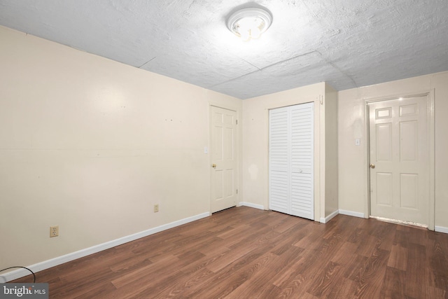 207 Wilderness Ln, Fredericksburg, VA 22401 - unfurnished bedroom featuring dark wood-type flooring, baseboards, and a closet