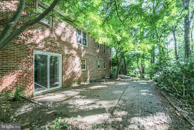 207 Wilderness Ln, Fredericksburg, VA 22401 - view of side of home with brick siding and a patio area