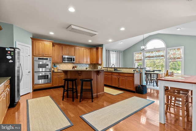 8 Warwick Ct, Newtown, PA 18940 - kitchen featuring stainless steel appliances, a kitchen bar, a sink, decorative backsplash, and a kitchen island