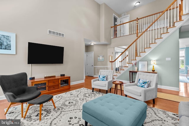 8 Warwick Ct, Newtown, PA 18940 - living area featuring stairway, wood finished floors, baseboards, and a towering ceiling
