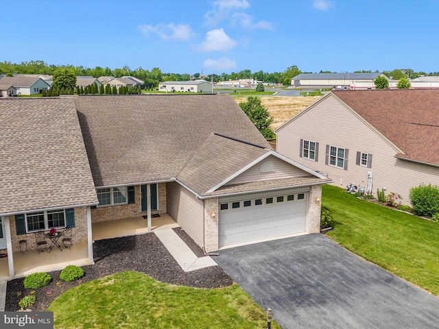 262 Lantern Ln, Chambersburg, PA 17201 - view of front of home with brick siding, an attached garage, asphalt driveway, a front yard, and roof with shingles