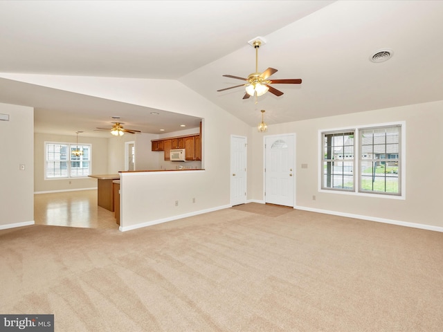 262 Lantern Ln, Chambersburg, PA 17201 - unfurnished living room with light colored carpet, ceiling fan, vaulted ceiling, and baseboards