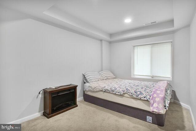 107 Main Ave SW, Glen Burnie, MD 21061 - carpeted bedroom featuring a tray ceiling, baseboards, and recessed lighting