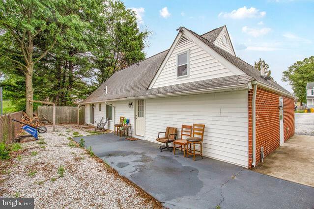 107 Main Ave SW, Glen Burnie, MD 21061 - rear view of house with a patio, a shingled roof, and brick siding