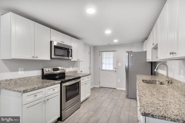 107 Main Ave SW, Glen Burnie, MD 21061 - kitchen featuring stainless steel appliances, a sink, white cabinets, baseboards, and recessed lighting