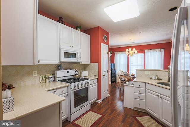 9601 Amberleigh Ln Unit 9601F, Perry Hall, MD 21128 - kitchen with white appliances, a sink, a chandelier, dark wood-style flooring, and a textured ceiling