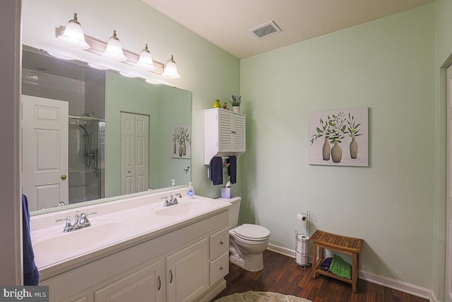 9601 Amberleigh Ln Unit 9601F, Perry Hall, MD 21128 - full bathroom with double vanity, a shower stall, wood finished floors, toilet, and baseboards