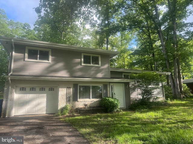30 Halleck Dr, East Berlin, PA 17316 - view of front of home with an attached garage, a front yard, asphalt driveway, and brick siding