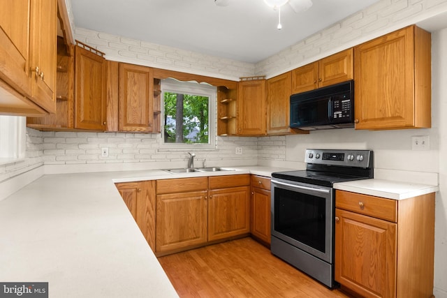 30 Halleck Dr, East Berlin, PA 17316 - kitchen with black microwave, stainless steel electric stove, a sink, open shelves, and light countertops