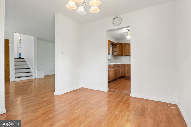 30 Halleck Dr, East Berlin, PA 17316 - unfurnished dining area featuring stairs, a chandelier, light wood finished floors, baseboards, and a ceiling fan
