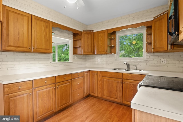 30 Halleck Dr, East Berlin, PA 17316 - kitchen featuring open shelves, a sink, black microwave, light wood-style flooring, and brown cabinets