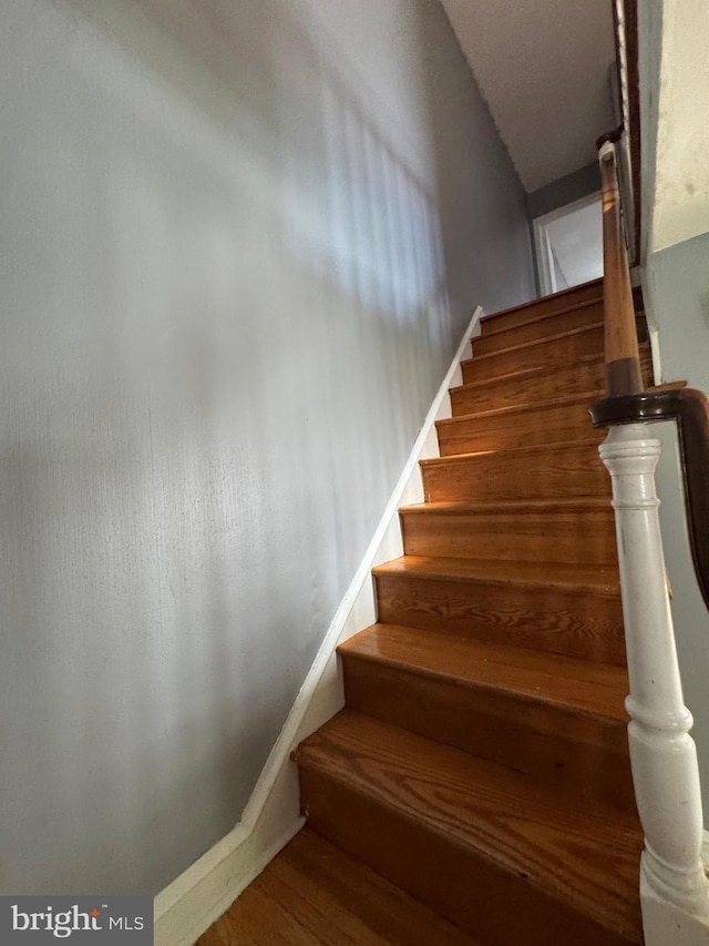 stairway featuring wood finished floors