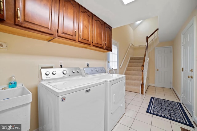 1292 Middleton Ct, Vienna, VA 22182 - laundry room featuring washing machine and dryer, cabinet space, and light tile patterned floors