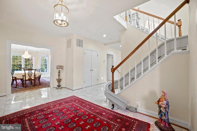 1292 Middleton Ct, Vienna, VA 22182 - foyer entrance featuring a chandelier, stairs, marble tiled floors, and baseboards