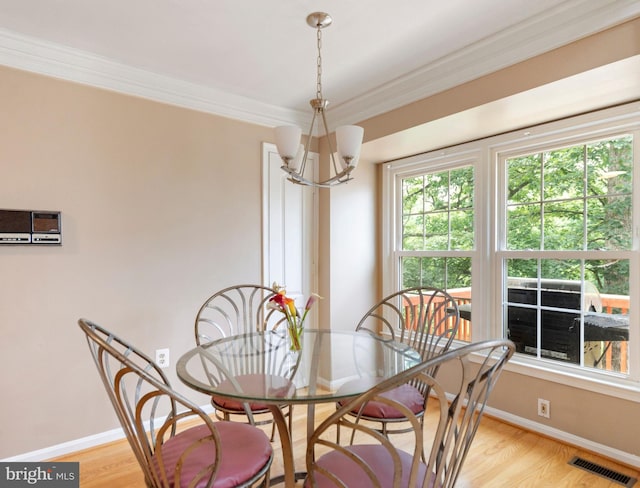 20245 Ordinary Pl, Ashburn, VA 20147 - dining area featuring a chandelier, crown molding, and light wood finished floors