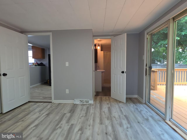 131 Vine St, Bridgeton, NJ 08302 - unfurnished bedroom featuring access to outside, multiple windows, light wood-style flooring, and baseboards