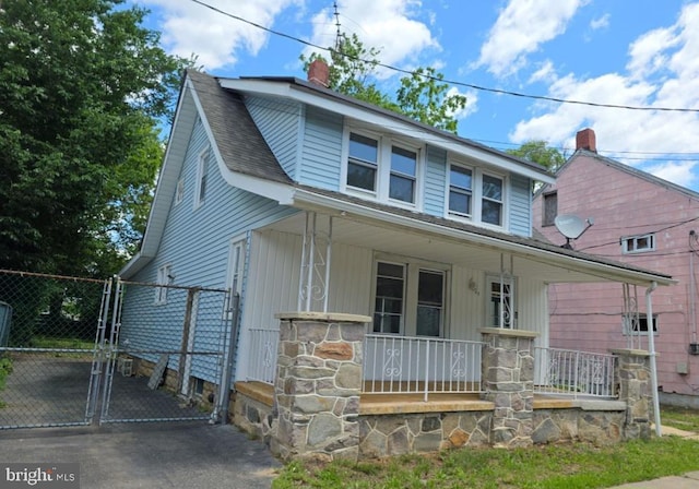 131 Vine St, Bridgeton, NJ 08302 - view of front of property with a porch, a gate, and a chimney