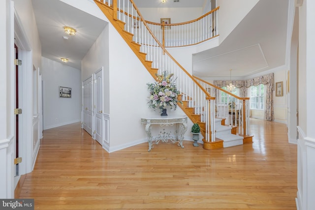 144 Cedar Ct, Woolwich Twp, NJ 08085 - foyer entrance with stairway, wood finished floors, a towering ceiling, baseboards, and a chandelier