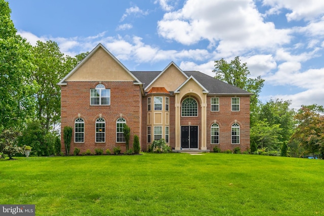 144 Cedar Ct, Woolwich Twp, NJ 08085 - view of front of home featuring a front lawn, brick siding, and stucco siding
