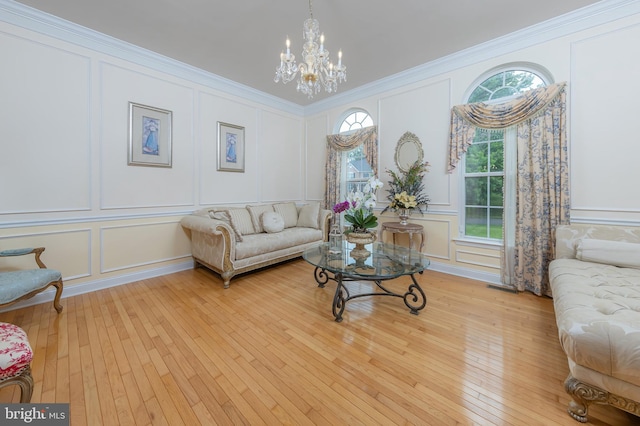 144 Cedar Ct, Woolwich Twp, NJ 08085 - living area featuring a decorative wall, a chandelier, light wood-style floors, and ornamental molding