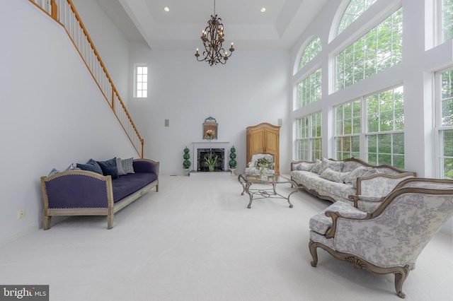 144 Cedar Ct, Woolwich Twp, NJ 08085 - living area featuring a chandelier, a towering ceiling, a tray ceiling, carpet floors, and recessed lighting