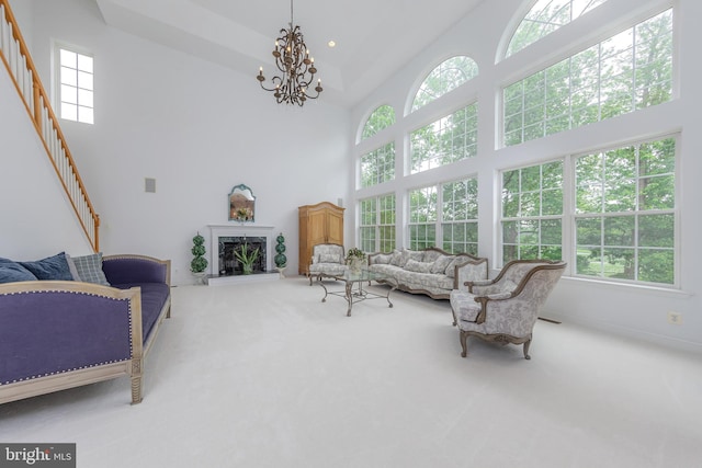 144 Cedar Ct, Woolwich Twp, NJ 08085 - carpeted living area with a towering ceiling, stairway, and a chandelier