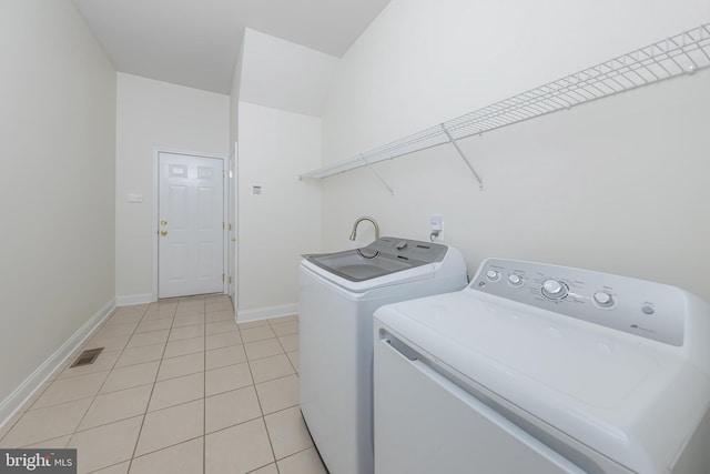 144 Cedar Ct, Woolwich Twp, NJ 08085 - laundry room featuring washer and dryer, light tile patterned floors, and baseboards
