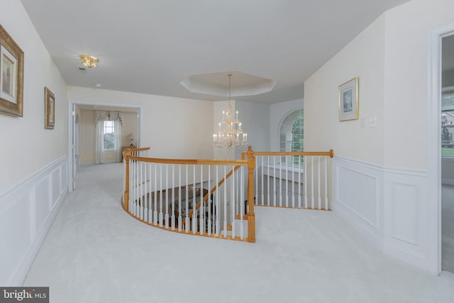 144 Cedar Ct, Woolwich Twp, NJ 08085 - corridor featuring an upstairs landing, a chandelier, carpet, a decorative wall, and a wainscoted wall