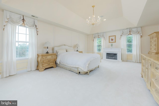 144 Cedar Ct, Woolwich Twp, NJ 08085 - bedroom featuring light colored carpet, a chandelier, a raised ceiling, and a glass covered fireplace