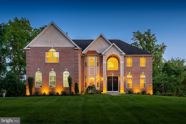 144 Cedar Ct, Woolwich Twp, NJ 08085 - colonial inspired home featuring a front lawn, brick siding, and stucco siding