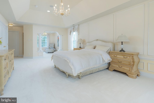 144 Cedar Ct, Woolwich Twp, NJ 08085 - bedroom featuring a chandelier, light carpet, a tray ceiling, and arched walkways