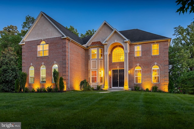 144 Cedar Ct, Woolwich Twp, NJ 08085 - colonial-style house with brick siding, a front lawn, and stucco siding