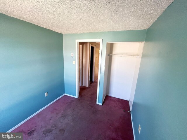 1222 N Calhoun St, Baltimore, MD 21217 - unfurnished bedroom with a closet, a textured ceiling, baseboards, and carpet flooring