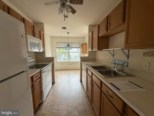 87 Courtyard Dr, Carlisle, PA 17013 - kitchen with white appliances, a sink, brown cabinetry, light countertops, and ceiling fan