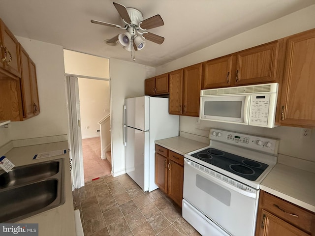 87 Courtyard Dr, Carlisle, PA 17013 - kitchen with white appliances, brown cabinets, a sink, ceiling fan, and light countertops