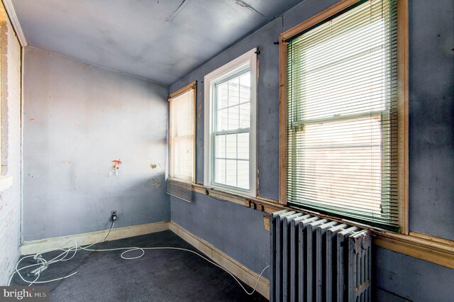 1646 Gales St NE, Washington, DC 20002 - spare room with radiator heating unit, plenty of natural light, carpet floors, and baseboards
