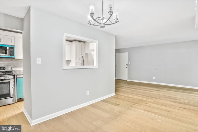 8001 Chanute Pl Unit 16/5, Falls Church, VA 22042 - unfurnished dining area featuring a chandelier, light wood finished floors, and baseboards