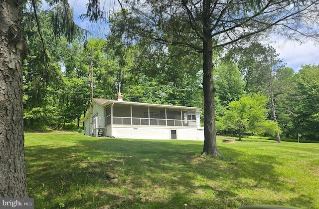 11 Maxwill Ln, Landisburg, PA 17040 - view of front facade with a sunroom, a front yard, and a chimney