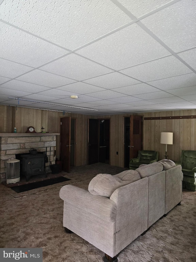 11 Maxwill Ln, Landisburg, PA 17040 - living area with a drop ceiling, carpet flooring, wooden walls, and a wood stove