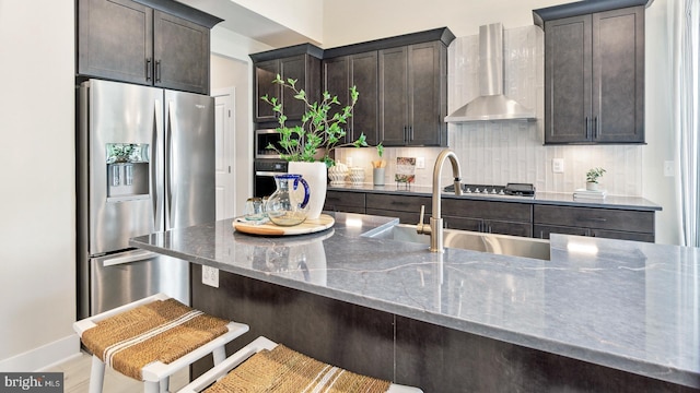 TBB Marsh Elder Rd Dune, Unit Dune, Cambridge, MD 21613 - kitchen featuring stainless steel fridge with ice dispenser, wall chimney exhaust hood, dark stone counters, a sink, and dark brown cabinetry